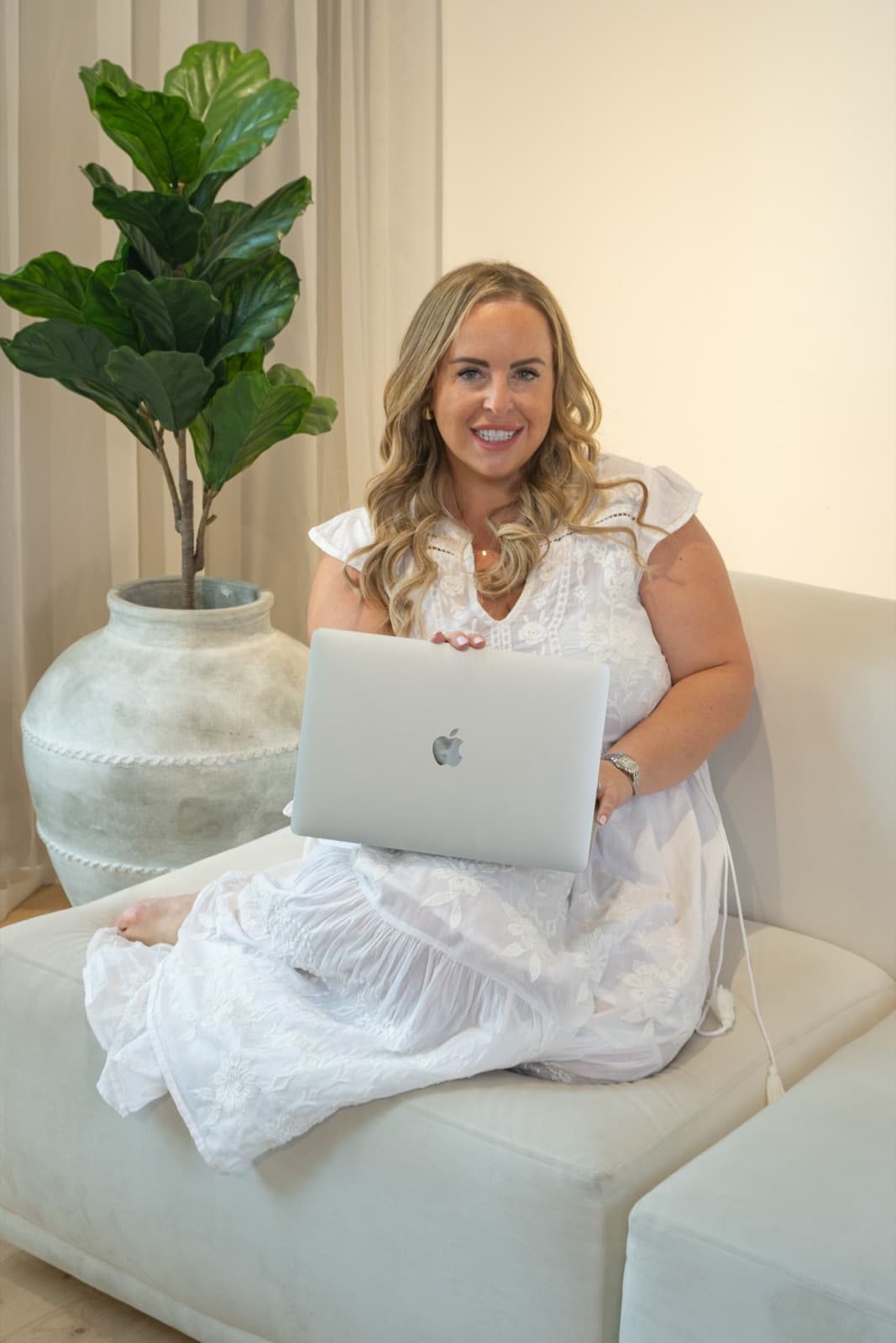 Annie Stacey, Taggy's COO, sitting on a sofa with a laptop